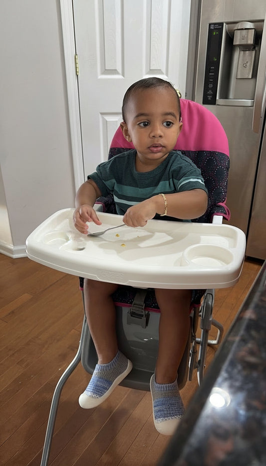 Child in a high chair eating at home