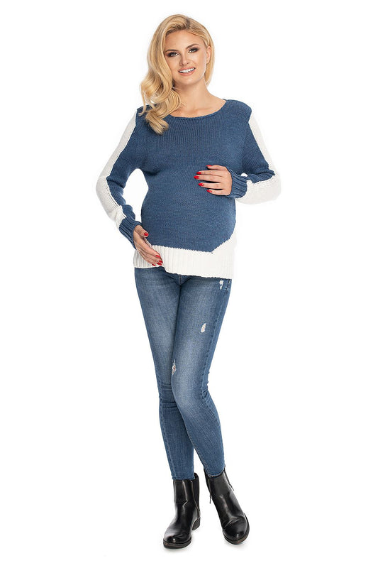 Woman wearing a blue and white sweater with jeans on a white background