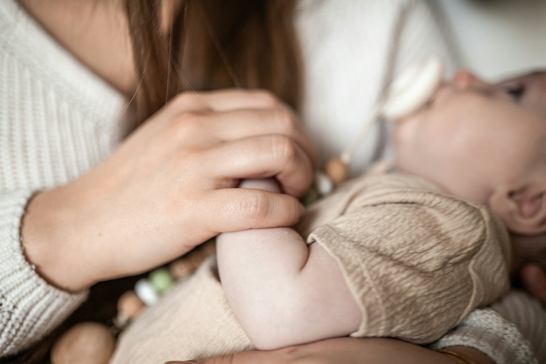a close up of a person holding a baby