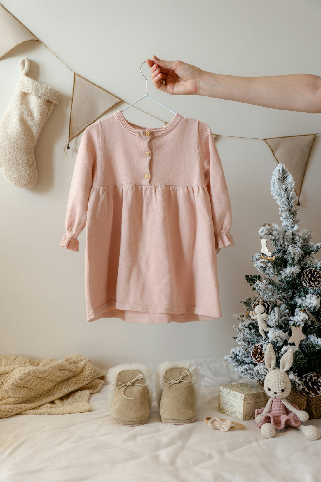 A baby's pink shirt hanging on a clothes line
