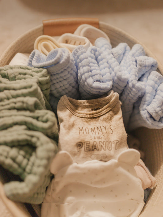 Baby clothes in a woven basket