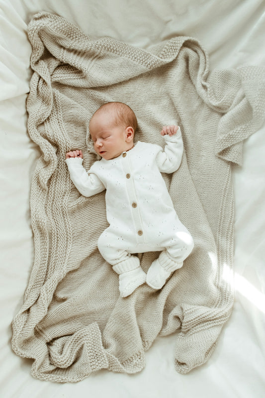 Newborn baby sleeping peacefully on a soft blanket