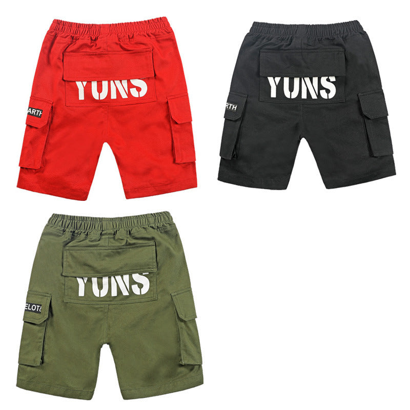 Three cargo shorts in red, black, and green with back pockets and 'YUNS' logo on white text