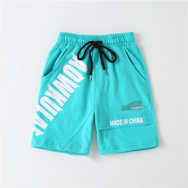 Turquoise casual shorts with black drawstring and white bold text designs, including 'AOWKULA' and 'MADE IN CHINA'