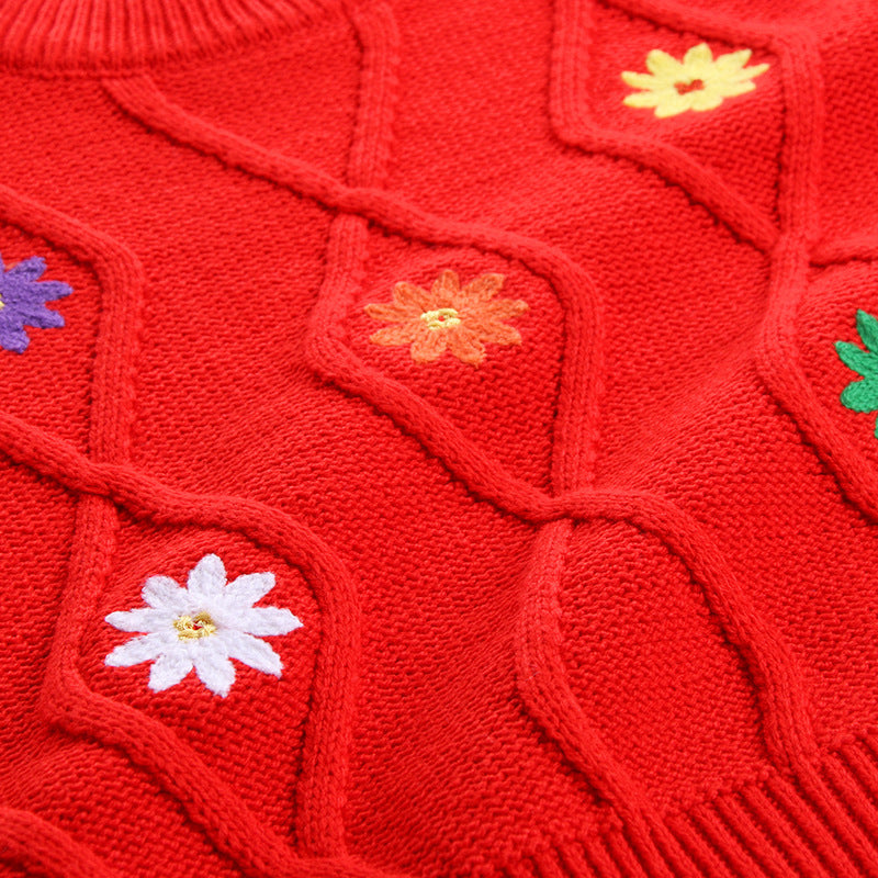 Red knitted sweater with colorful embroidered floral patterns and textured cable knit design