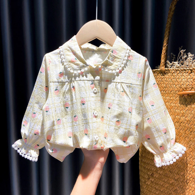 Baby blouse with floral and plaid print, scalloped lace collar and cuffs, hanging on wooden hanger