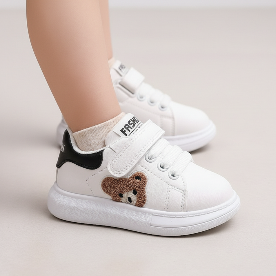 White sneakers with a teddy bear design on a light background