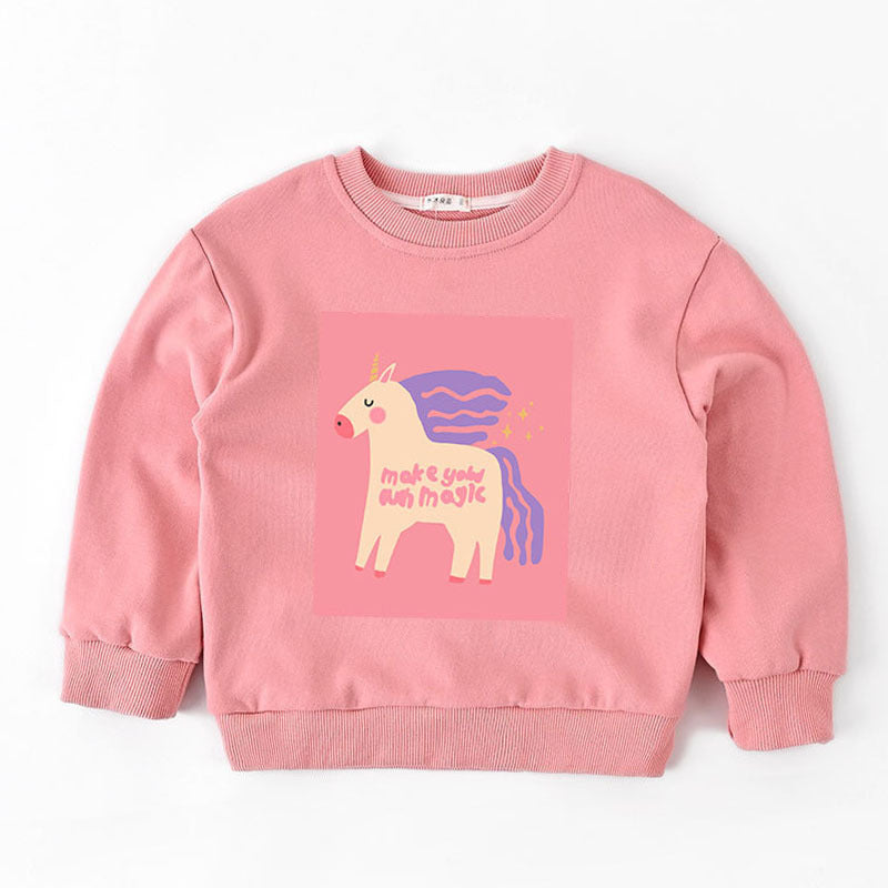 Pink kids sweatshirt with a unicorn graphic and text 'make your own magic' on front