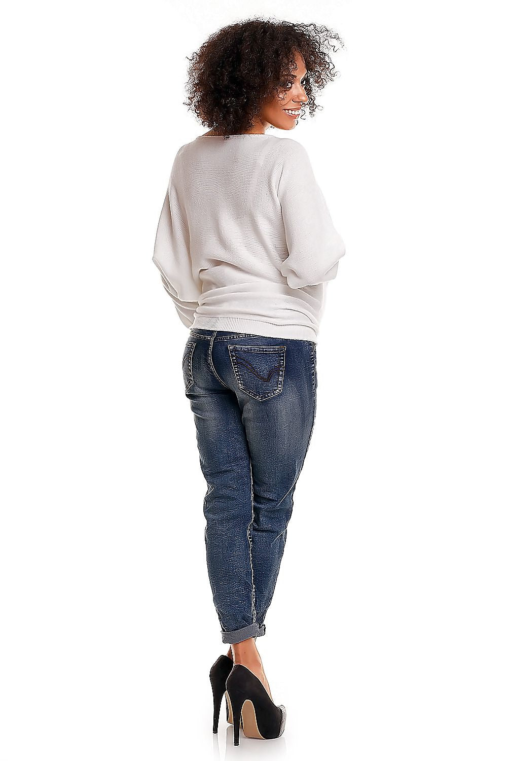 Woman wearing a white sweater and blue jeans on a white background