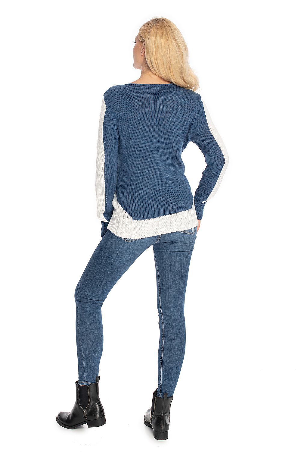 Woman wearing a blue sweater and jeans on a white background